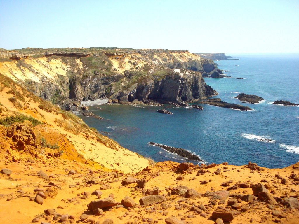 Die orangenroten Klippen am Weg von Almograve zum Cabo Sardão